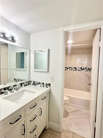 a bathroom with a sink a shower and a mirror