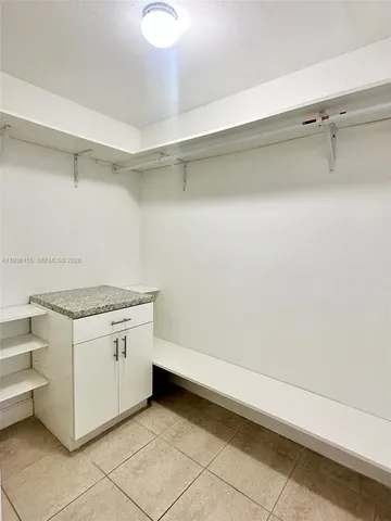 a view of a kitchen with white cabinets