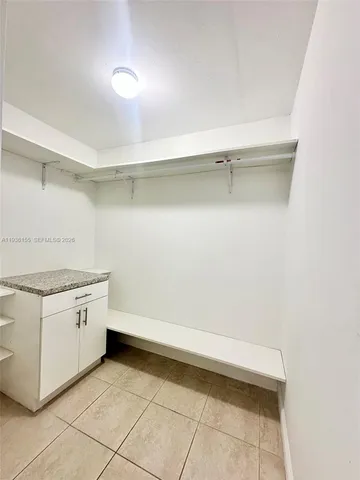 a kitchen with white cabinets and white appliances
