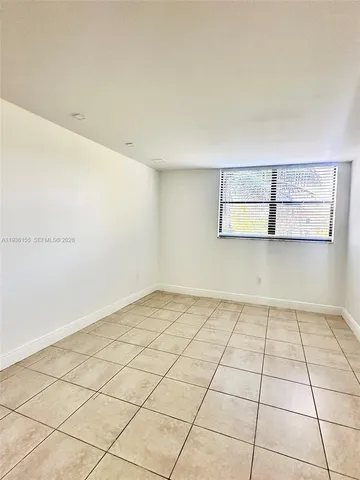 a view of a room with an empty space and window