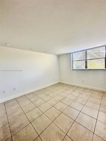a view of a room with an empty space and a window