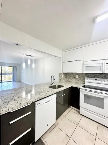 a kitchen with granite countertop cabinets and stainless steel appliances