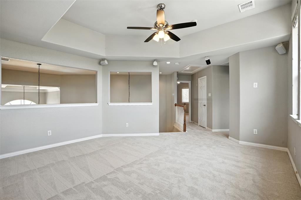 8220 Holliday Road Lantana, TX 76226 - Photo 30 of 40 Carpeted room featuring a tray ceiling with a built-in ceiling fan, recessed lighting, and integrated wall speakers