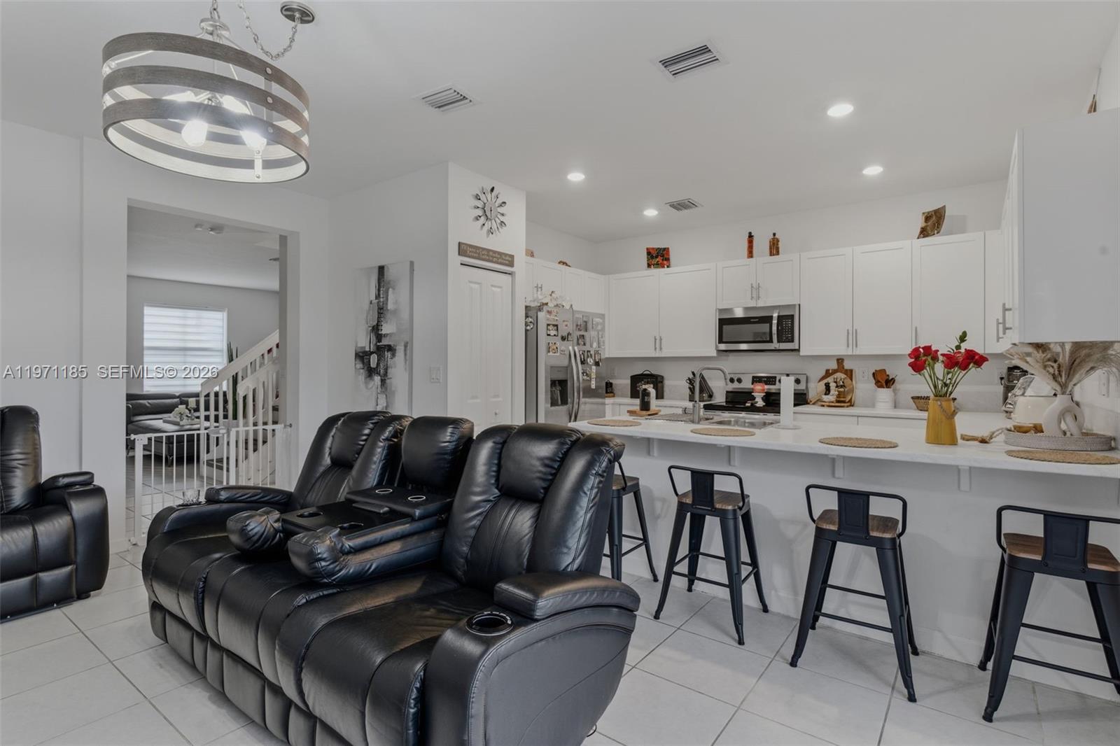 10009 Southwest 228th Terrace Miami, FL 33190 - Photo 12 of 48 a kitchen with stainless steel appliances granite countertop a stove a sink and a refrigerator