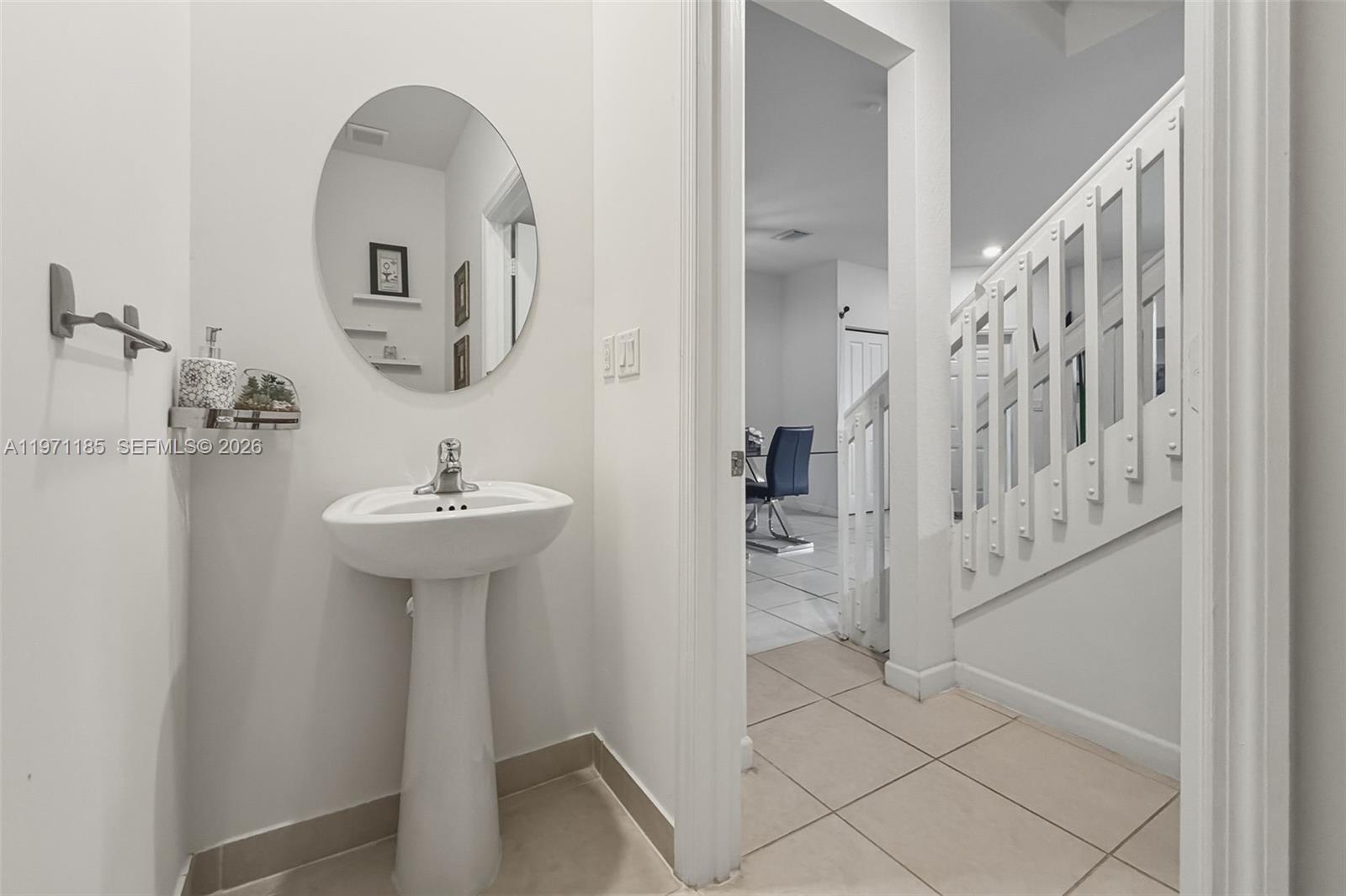 10009 Southwest 228th Terrace Miami, FL 33190 - Photo 13 of 48 a bathroom with a sink a mirror and shower