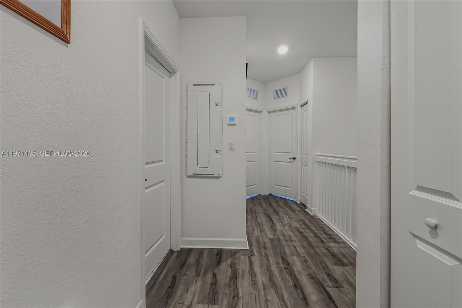 10009 Southwest 228th Terrace Miami, FL 33190 - Photo 16 of 48 a view of a hallway with wooden floor and a sink