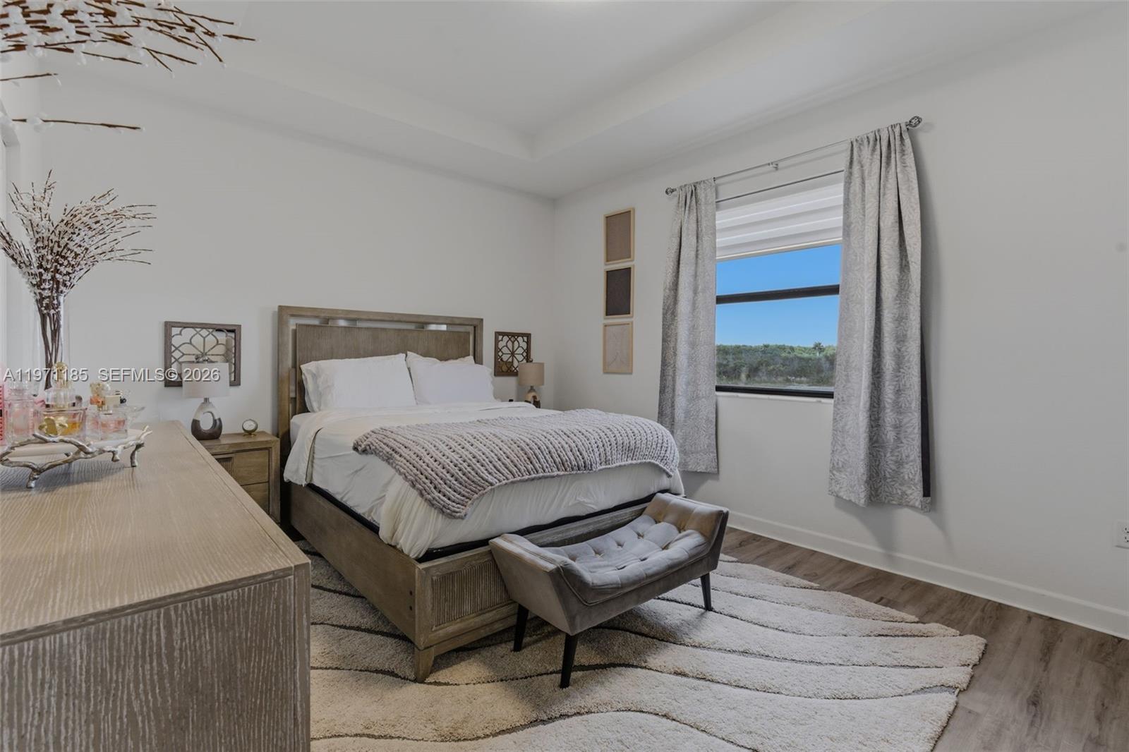 10009 Southwest 228th Terrace Miami, FL 33190 - Photo 20 of 48 a bedroom with a bed and wooden floor