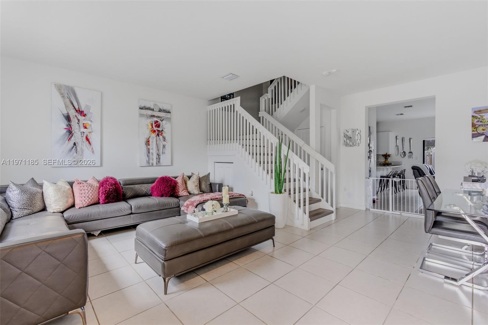 10009 Southwest 228th Terrace Miami, FL 33190 - Photo 2 of 48 a living room with furniture and stairs