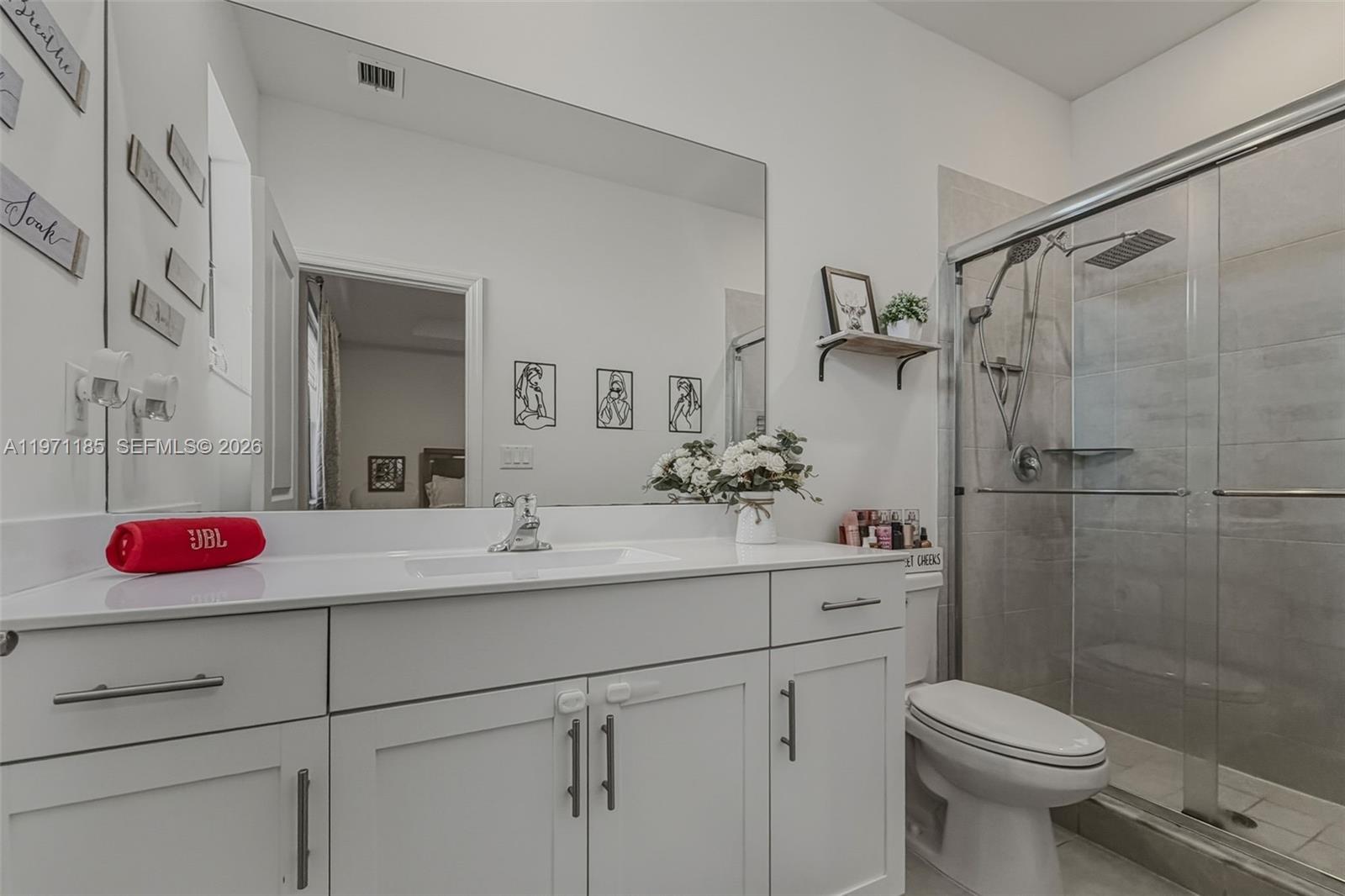 10009 Southwest 228th Terrace Miami, FL 33190 - Photo 22 of 48 a bathroom with a sink mirror vanity and toilet