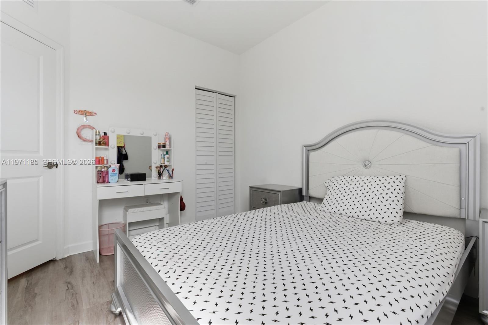 10009 Southwest 228th Terrace Miami, FL 33190 - Photo 23 of 48 a bedroom with a bed and a table