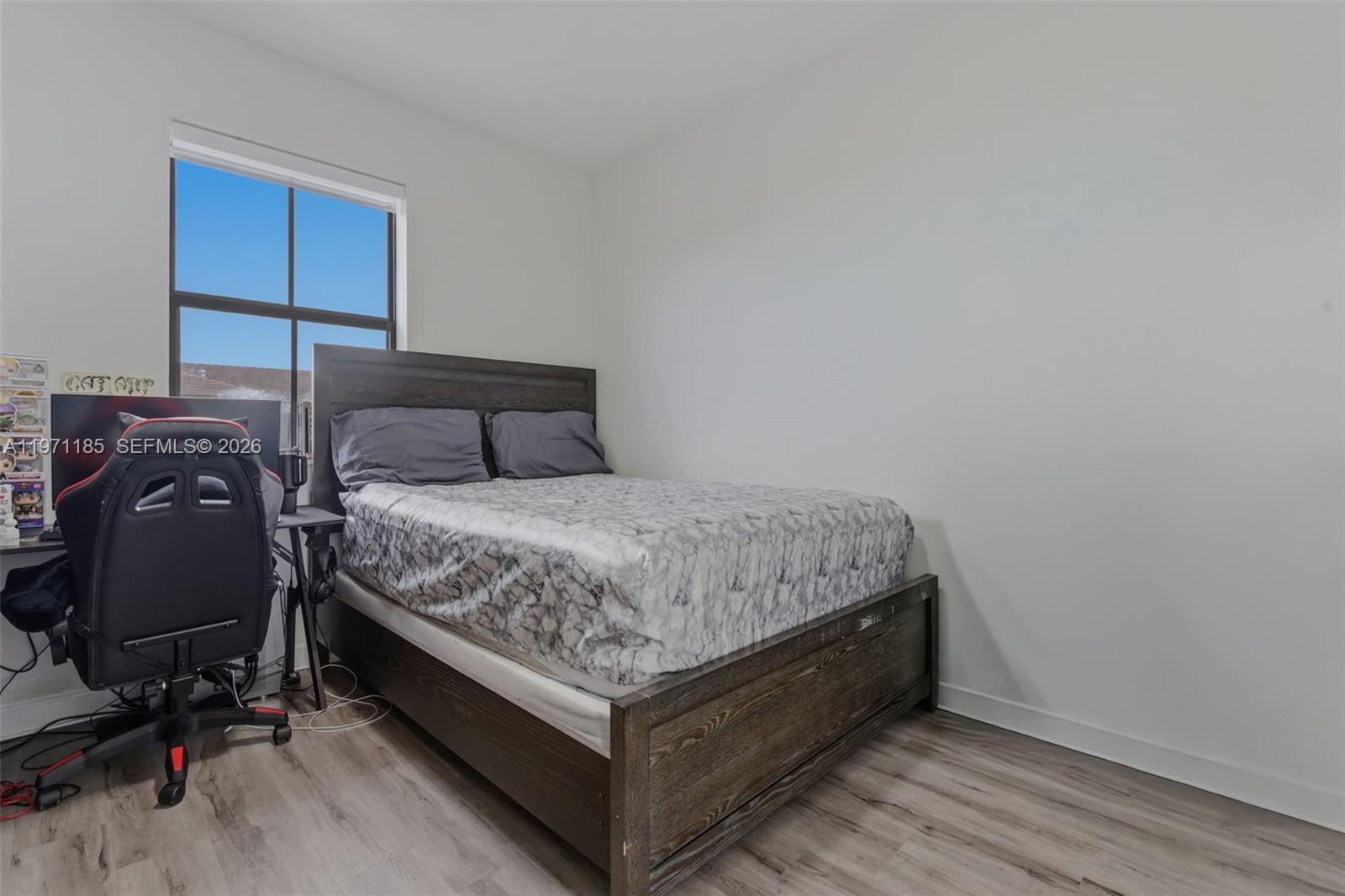 10009 Southwest 228th Terrace Miami, FL 33190 - Photo 27 of 48 a bedroom with a bed and wooden floor