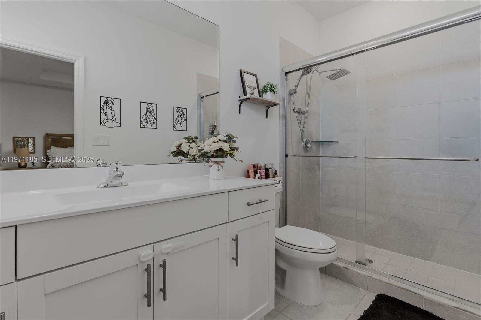 10009 Southwest 228th Terrace Miami, FL 33190 - Photo 29 of 48 a bathroom with a sink toilet vanity and shower