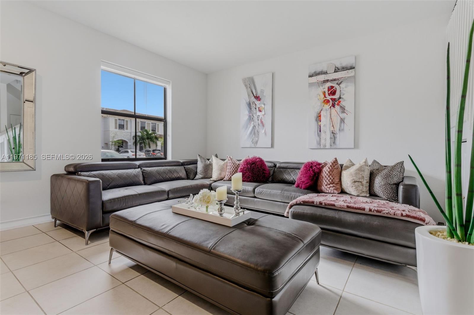 10009 Southwest 228th Terrace Miami, FL 33190 - Photo 3 of 48 a living room with furniture and a potted plant