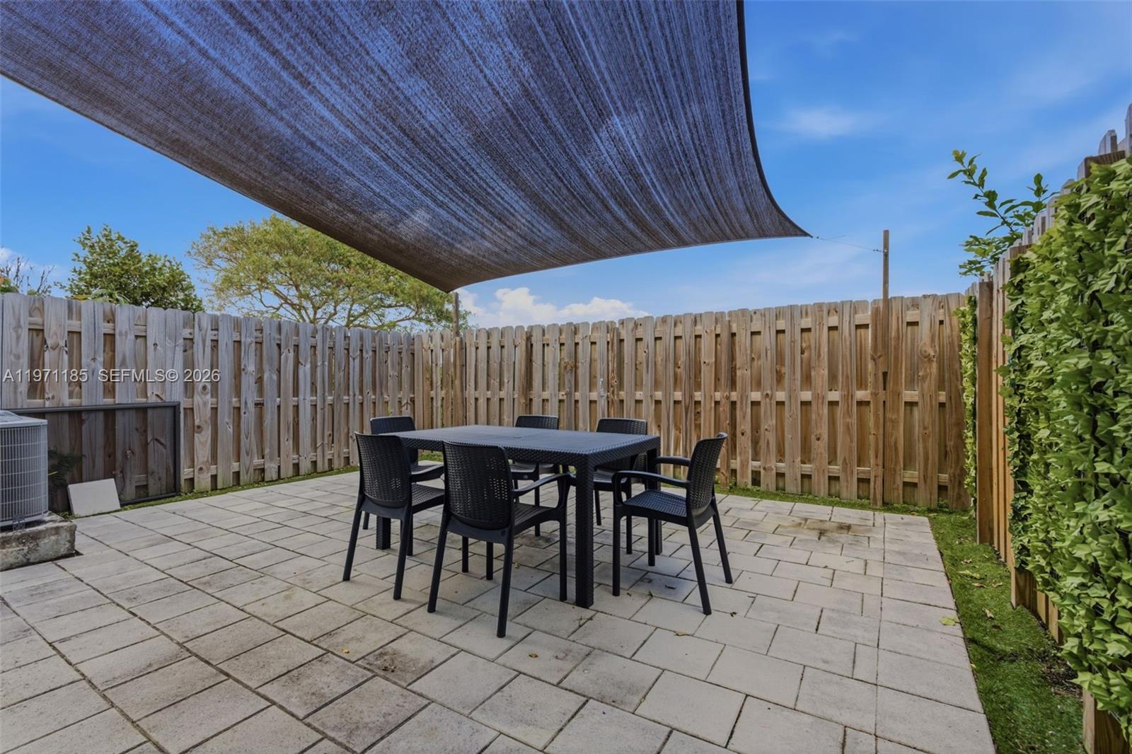 10009 Southwest 228th Terrace Miami, FL 33190 - Photo 32 of 48 a patio with table and chairs
