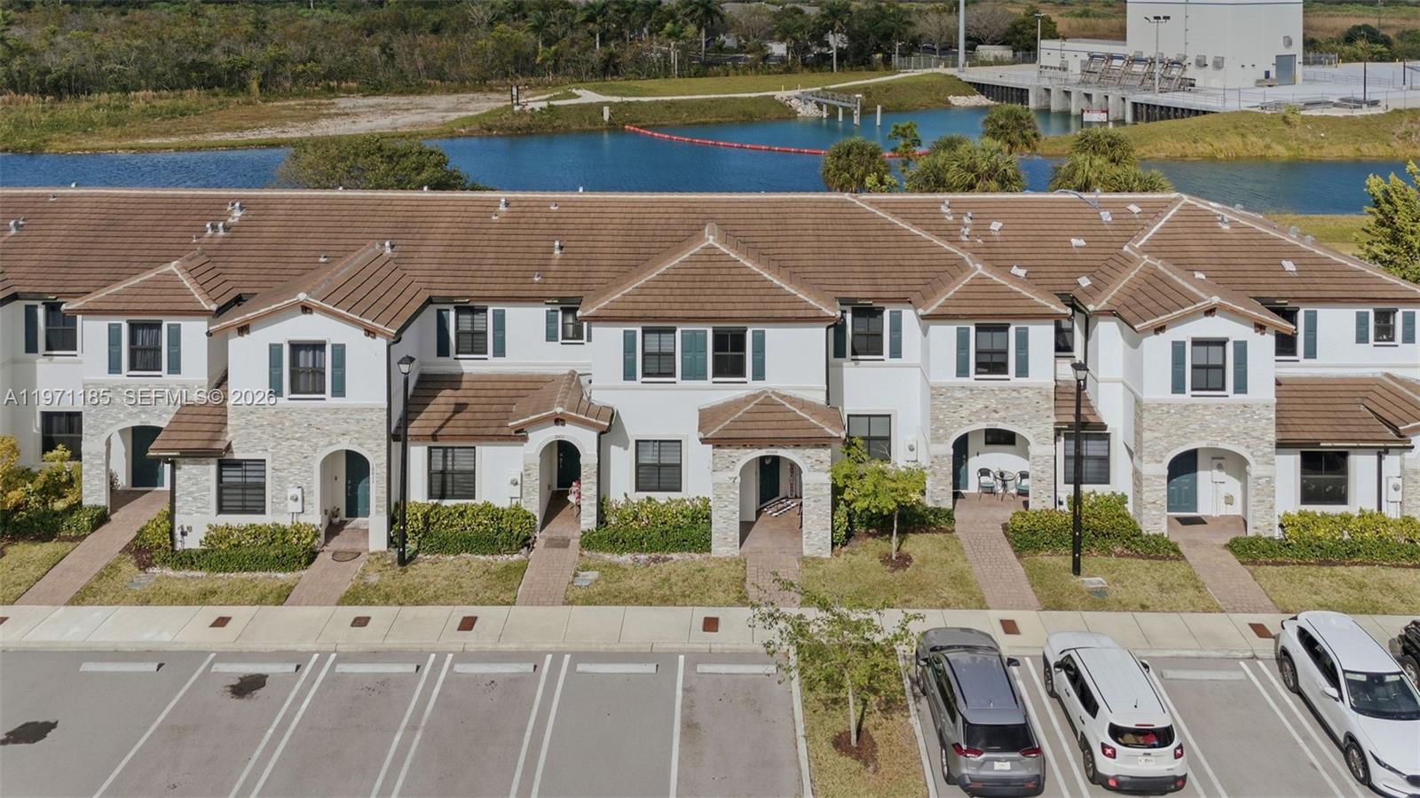 10009 Southwest 228th Terrace Miami, FL 33190 - Photo 37 of 48 a aerial view of a house with swimming pool and a yard