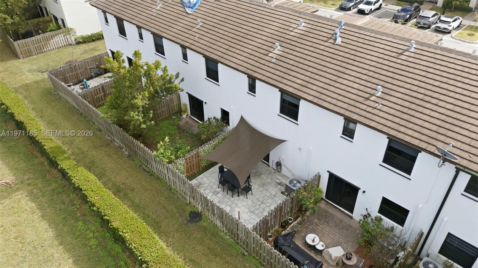 10009 Southwest 228th Terrace Miami, FL 33190 - Photo 39 of 48 a view of a patio with table and chairs with wooden floor