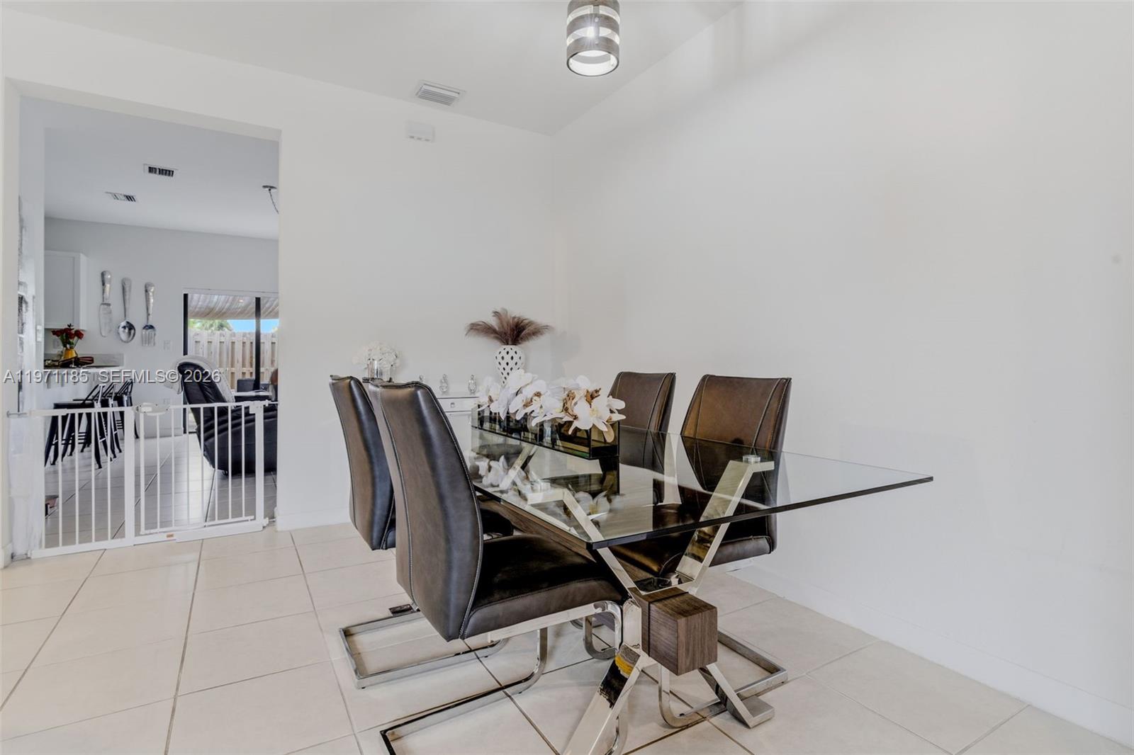 10009 Southwest 228th Terrace Miami, FL 33190 - Photo 5 of 48 a view of a workspace with furniture and a table