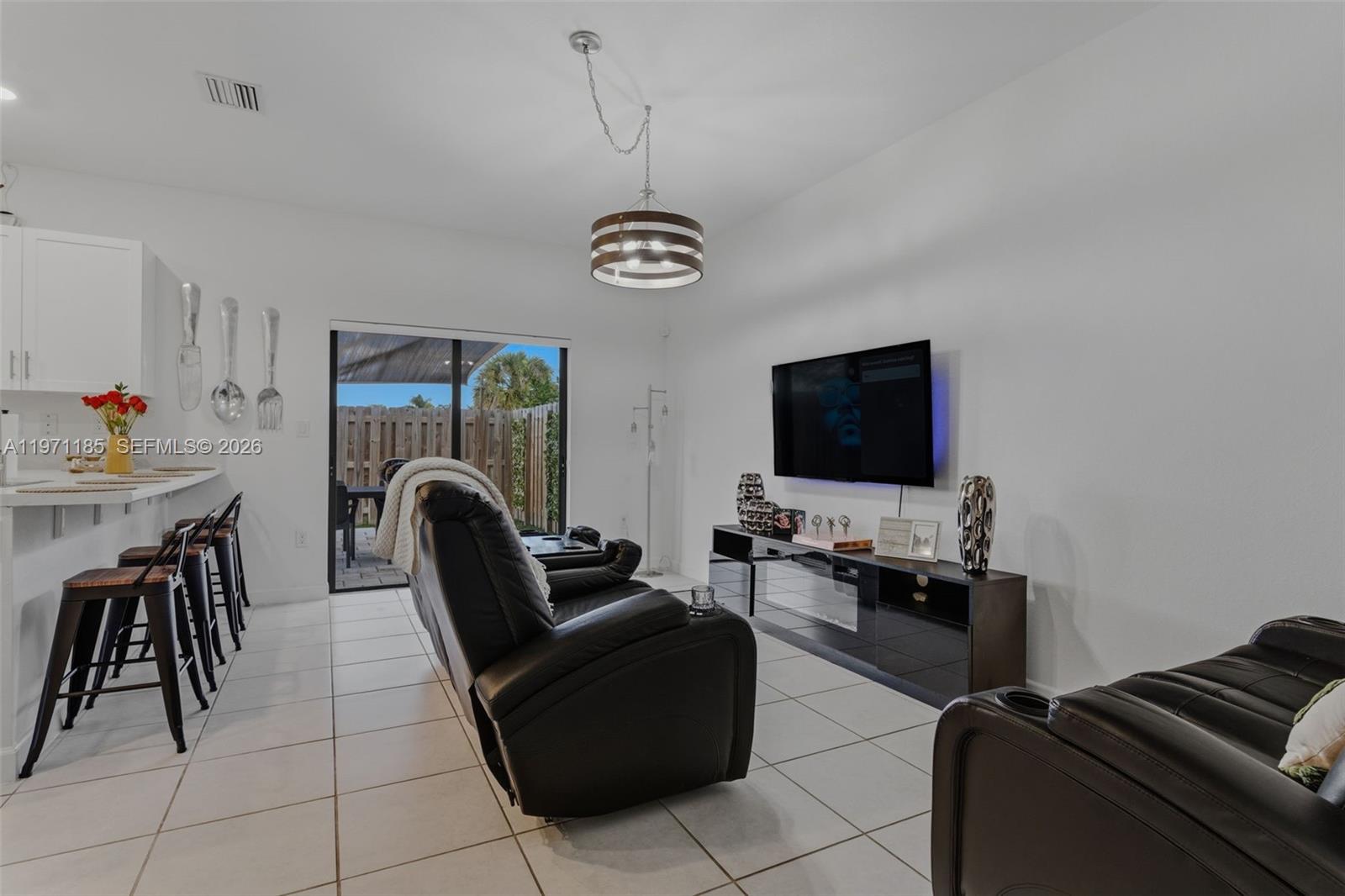 10009 Southwest 228th Terrace Miami, FL 33190 - Photo 7 of 48 a living room with furniture and a flat screen tv