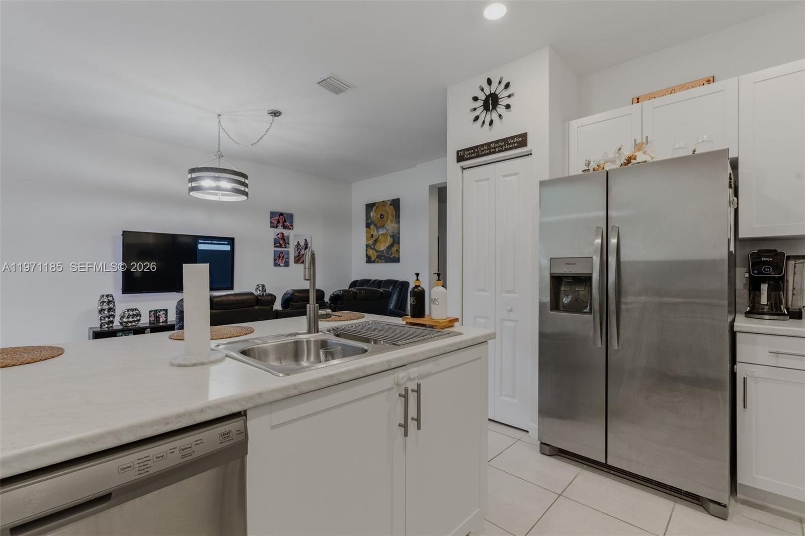 10009 Southwest 228th Terrace Miami, FL 33190 - Photo 8 of 48 a kitchen with kitchen island a counter top space cabinets and stainless steel appliances