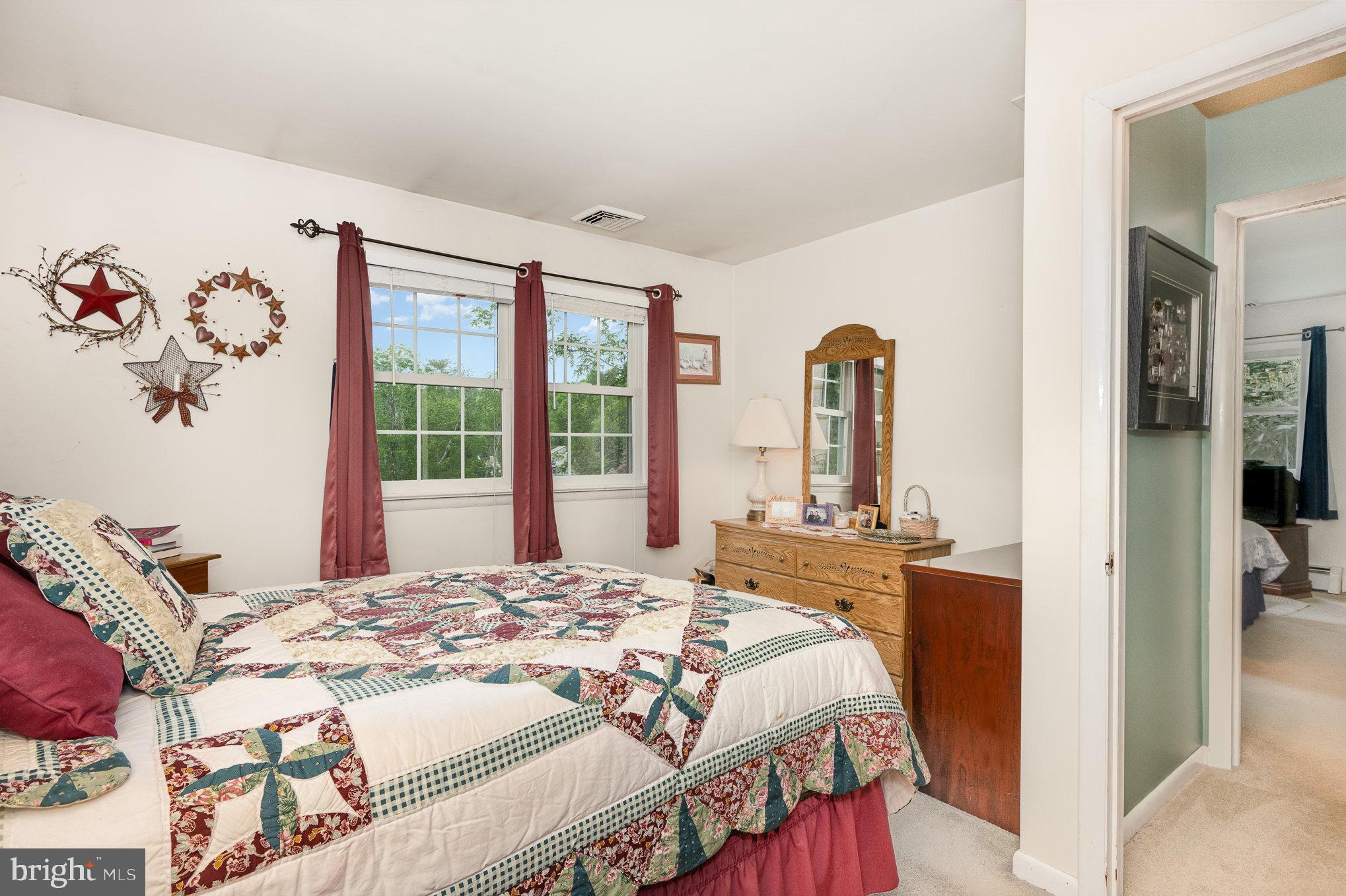 417 Ray Mar Road Oxford, PA 19363 - Photo 16 of 34 a bedroom with a bed and a large mirror next to a window