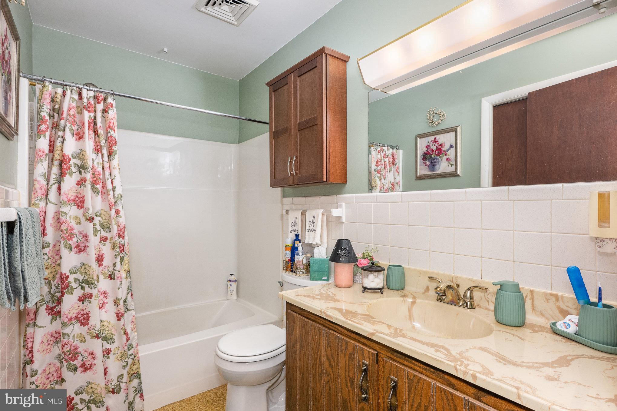 417 Ray Mar Road Oxford, PA 19363 - Photo 20 of 34 a bathroom with a sink a toilet and shower curtain