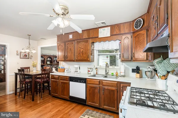 a kitchen with stainless steel appliances a stove a refrigerator and a sink
