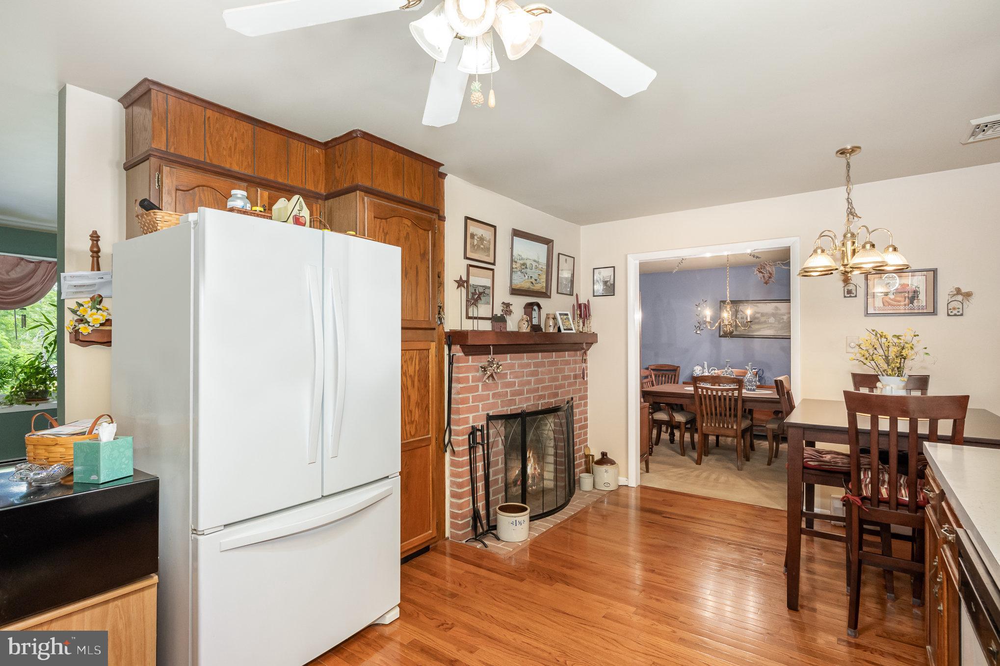 417 Ray Mar Road Oxford, PA 19363 - Photo 10 of 34 a dining room with wooden floor a chandelier a wooden table and chairs