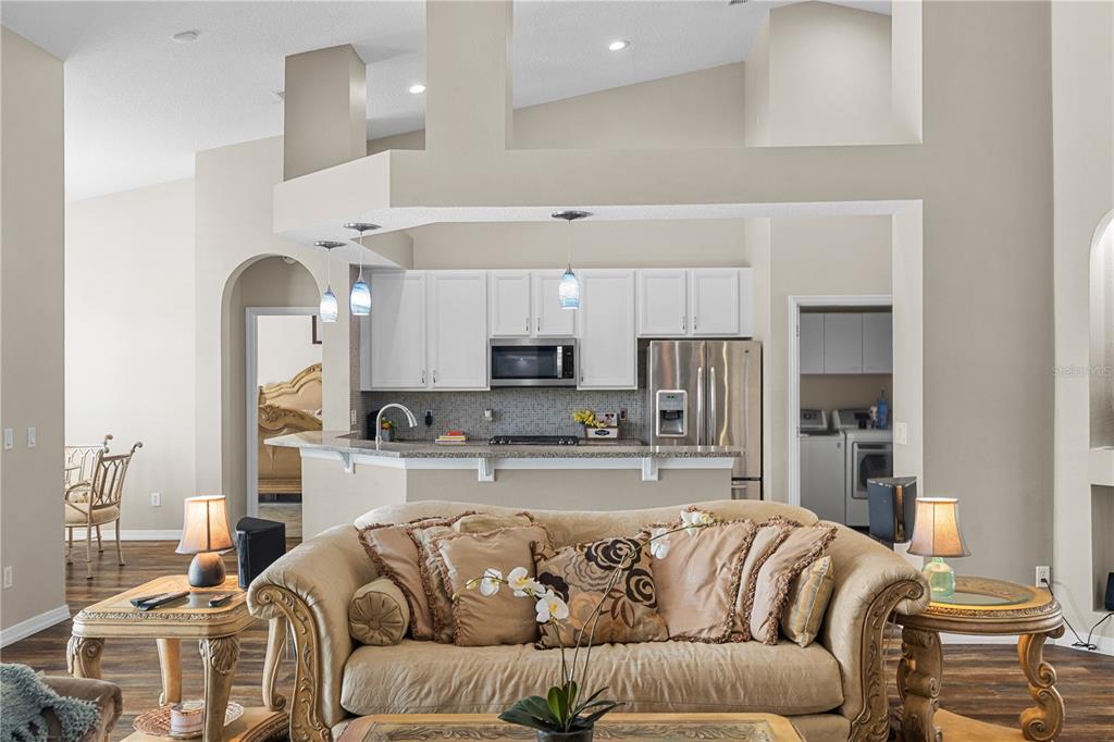 14624 Kitlanselt Way Orlando, FL 32828 - Photo 11 of 42 a living room with furniture kitchen and a fireplace
