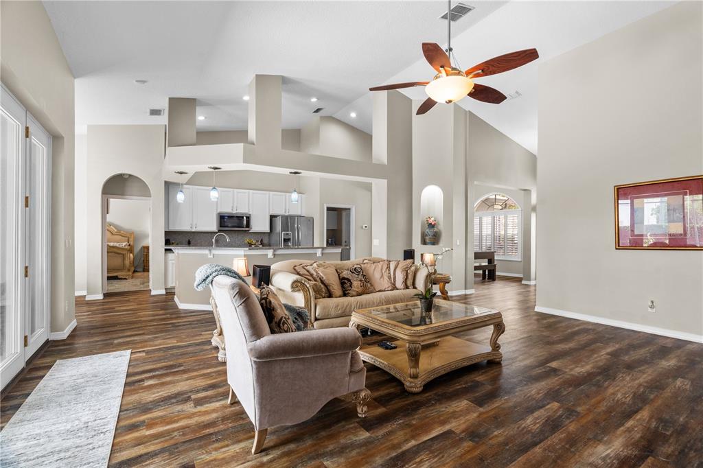 14624 Kitlanselt Way Orlando, FL 32828 - Photo 12 of 42 a living room with furniture kitchen view and a chandelier