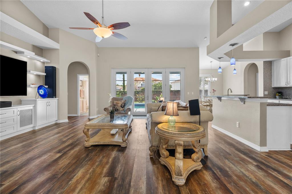 14624 Kitlanselt Way Orlando, FL 32828 - Photo 13 of 42 a living room with furniture a fireplace and a chandelier