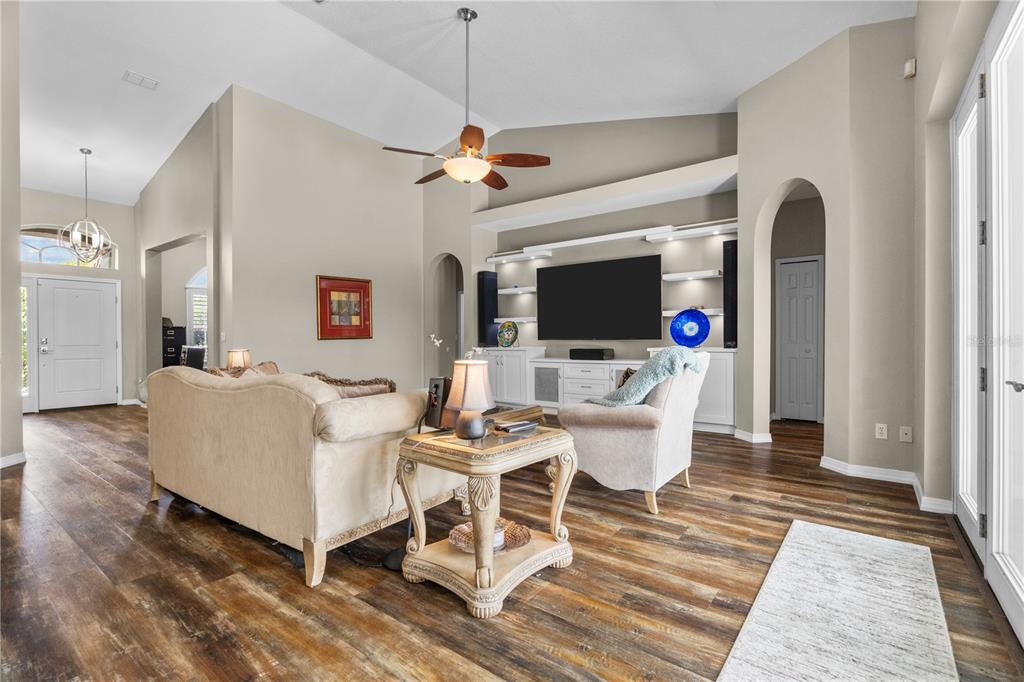 14624 Kitlanselt Way Orlando, FL 32828 - Photo 14 of 42 a living room with furniture a flat screen tv and a fireplace