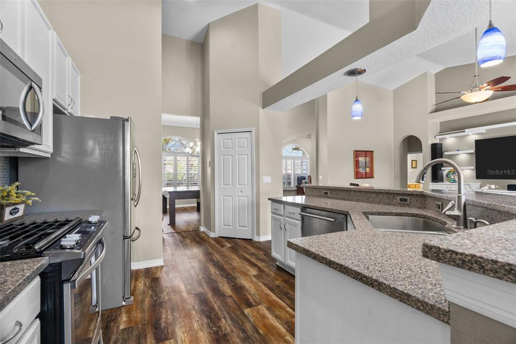 14624 Kitlanselt Way Orlando, FL 32828 - Photo 16 of 42 a kitchen with stainless steel appliances granite countertop a sink stove and refrigerator