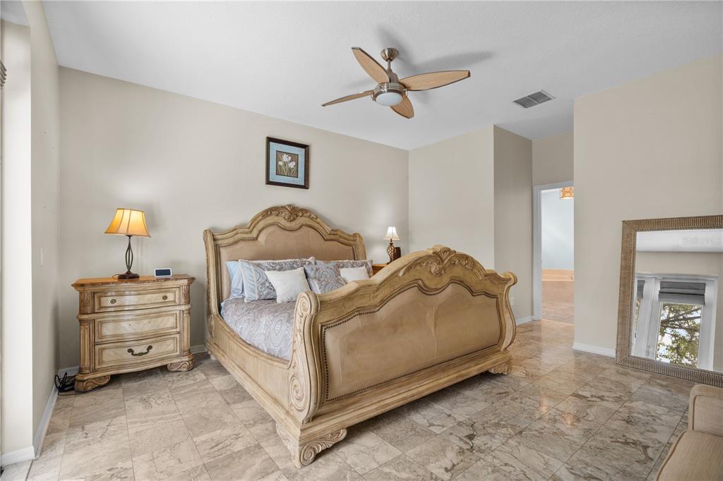 14624 Kitlanselt Way Orlando, FL 32828 - Photo 22 of 42 a bedroom with a bed and a chandelier