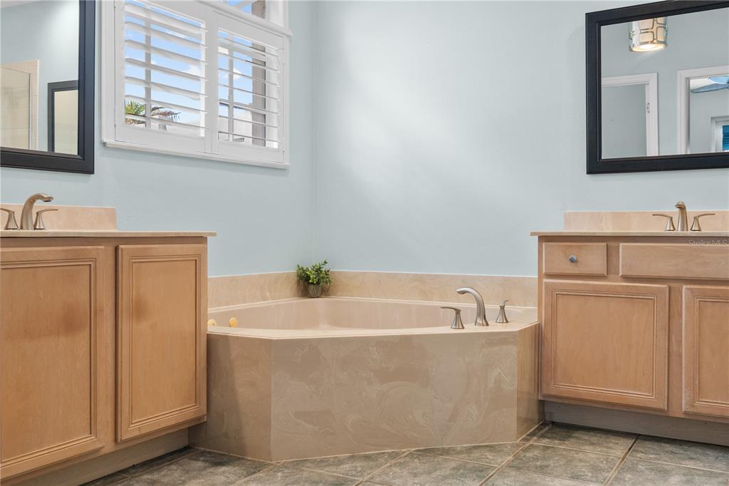 14624 Kitlanselt Way Orlando, FL 32828 - Photo 24 of 42 a white bath tub sitting next to a white sink