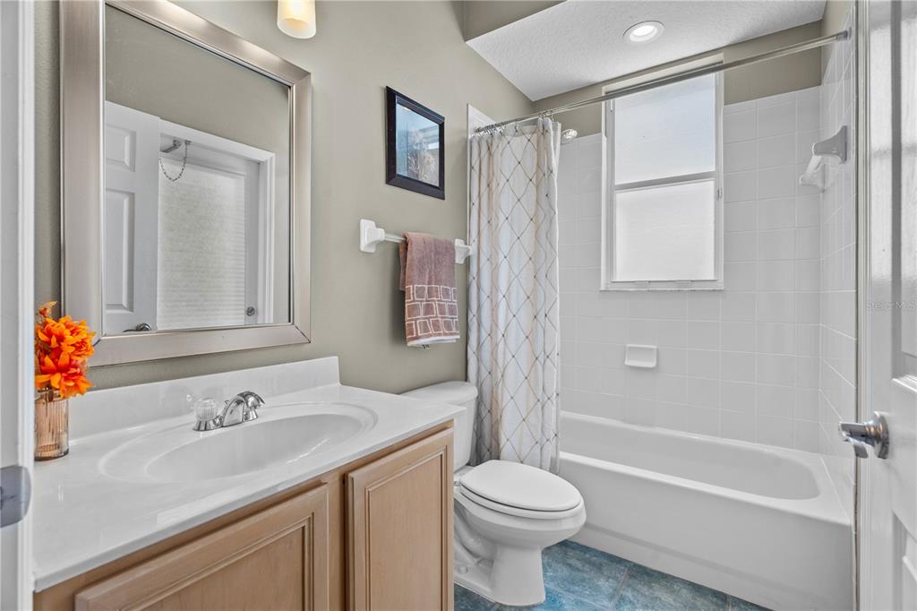 14624 Kitlanselt Way Orlando, FL 32828 - Photo 27 of 42 a bathroom with a granite countertop sink toilet and shower