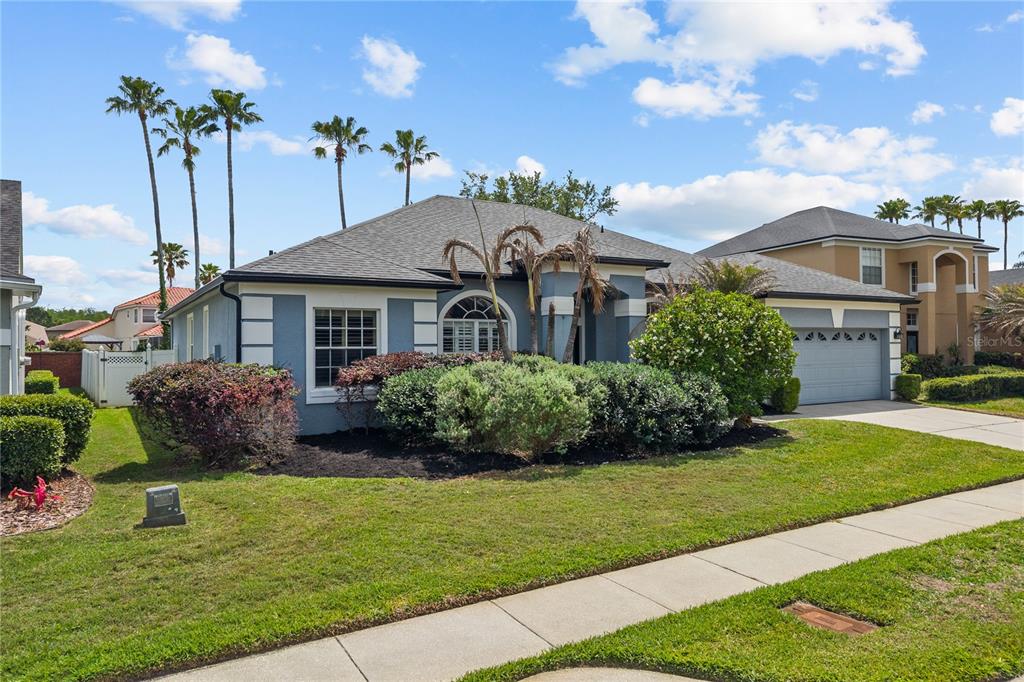 14624 Kitlanselt Way Orlando, FL 32828 - Photo 5 of 42 a front view of a house with a garden and plants