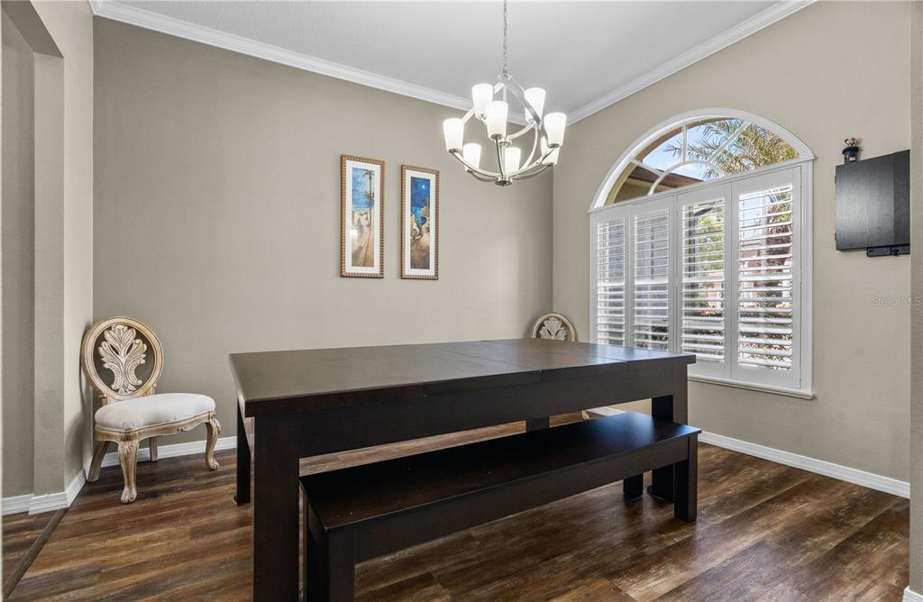 14624 Kitlanselt Way Orlando, FL 32828 - Photo 9 of 42 a view of workspace with wooden floor furniture and a window