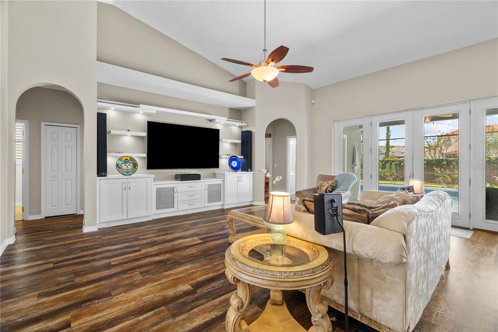 14624 Kitlanselt Way Orlando, FL 32828 - Photo 10 of 42 a living room with furniture a flat screen tv and a view of kitchen