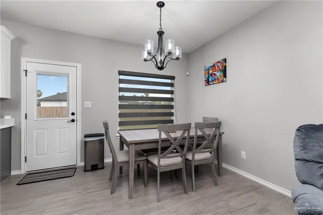 a view of a dining room with furniture wooden floor and a chandelier