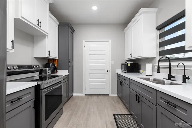 a kitchen with a sink stove and cabinets