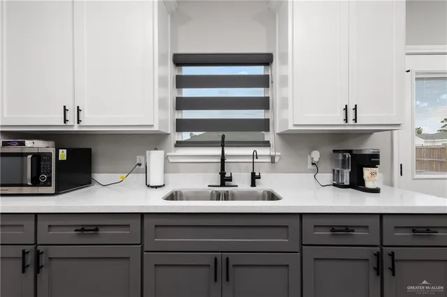 a kitchen with a sink and cabinets