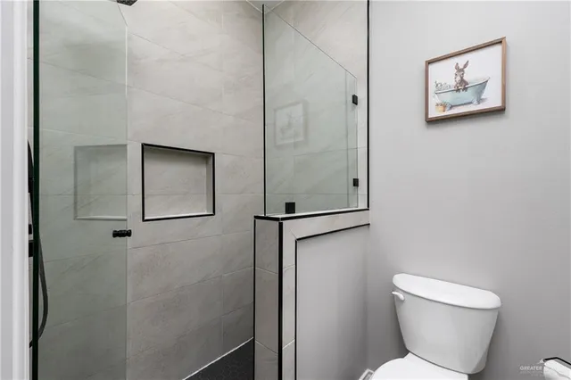 a bathroom with a toilet and a shower