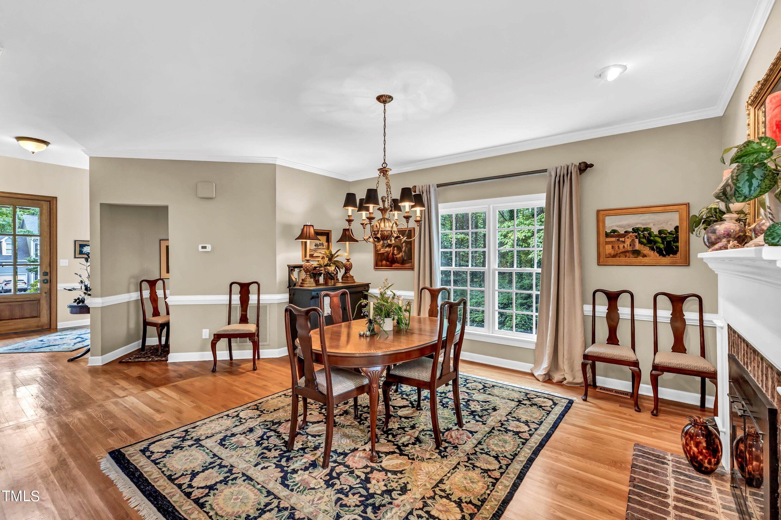 6105 Montcastle Court Raleigh, NC 27612 - Photo 11 of 44 a dining room with furniture a rug a rug and a window