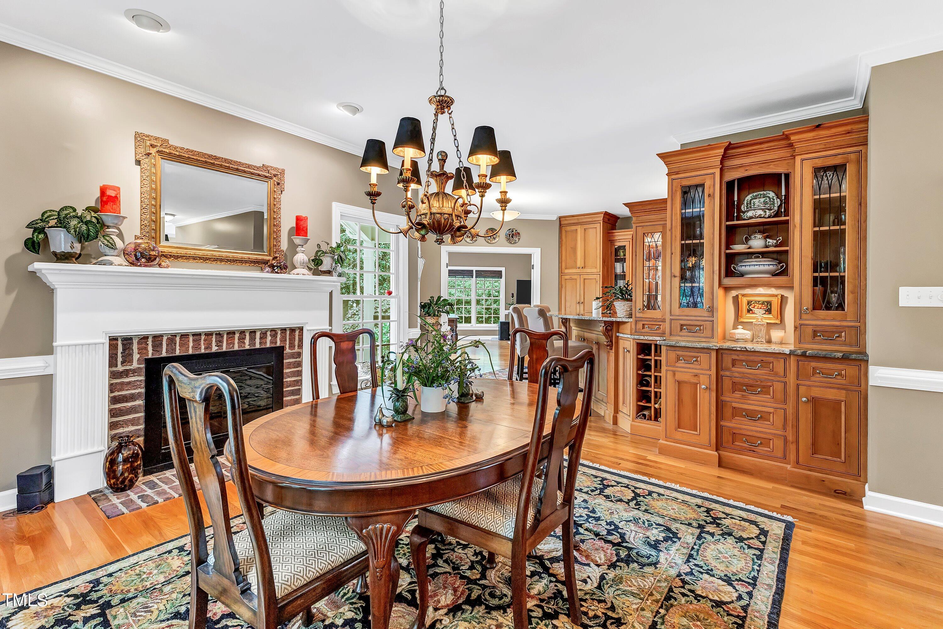 6105 Montcastle Court Raleigh, NC 27612 - Photo 13 of 44 a view of a dining room with furniture and chandelier