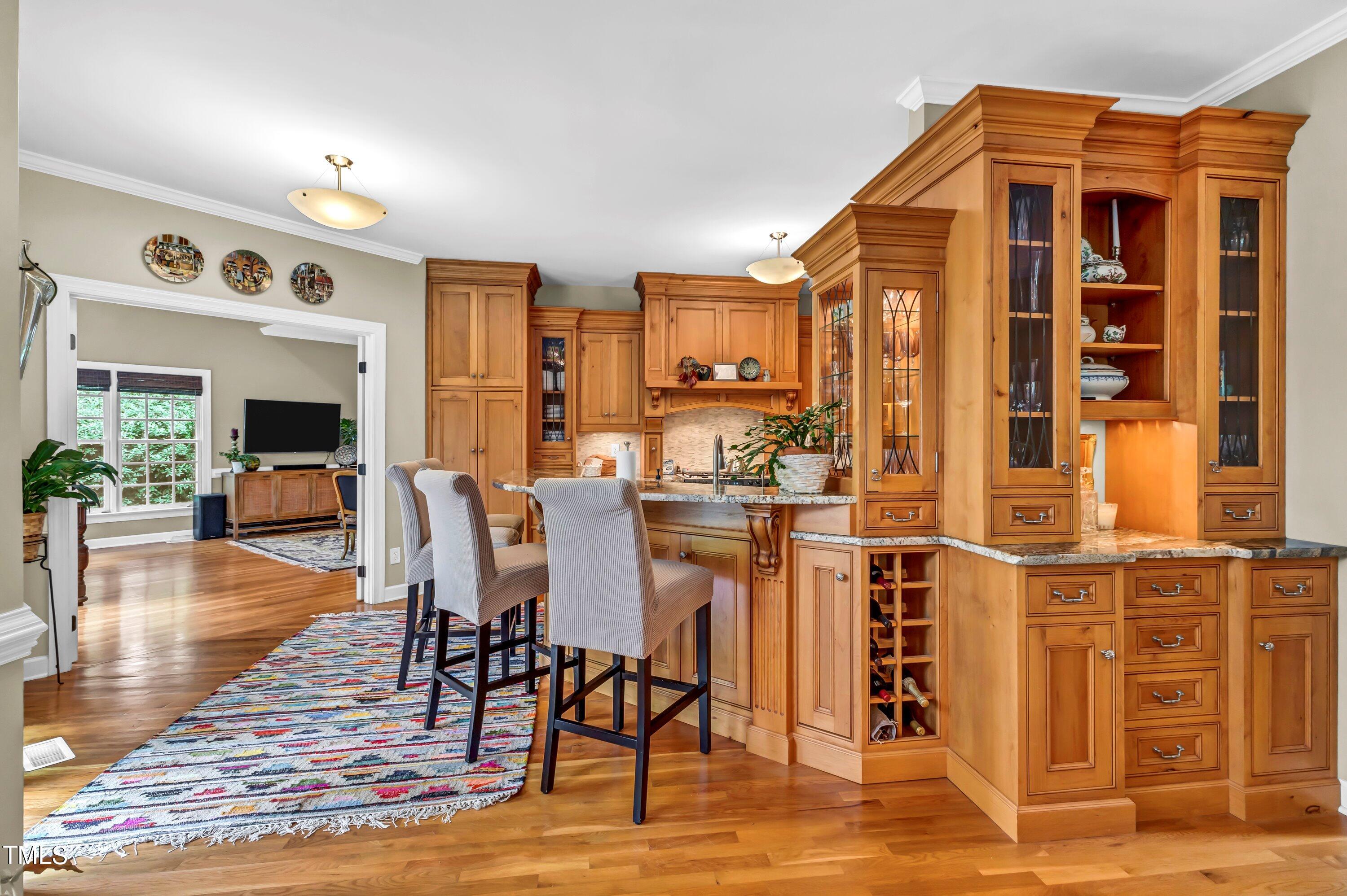 6105 Montcastle Court Raleigh, NC 27612 - Photo 14 of 44 a view of a dining room with furniture and wooden floor