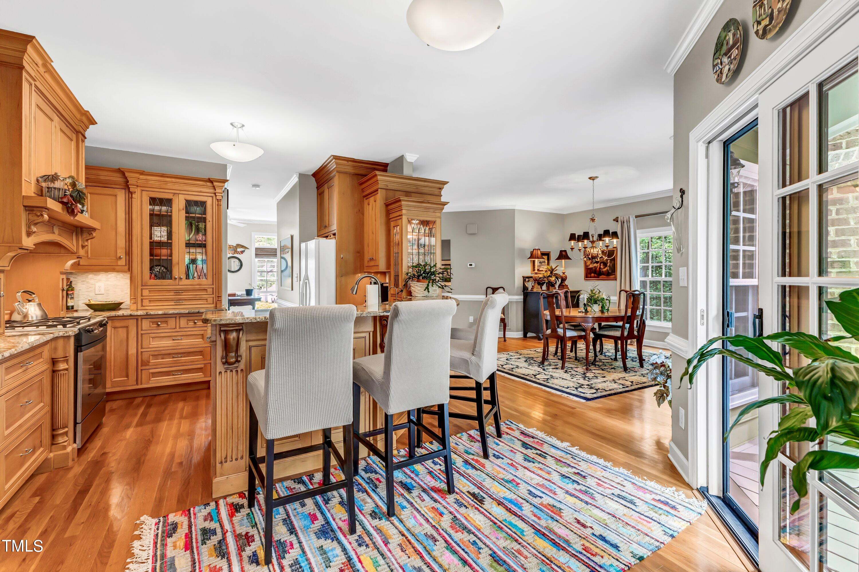 6105 Montcastle Court Raleigh, NC 27612 - Photo 15 of 44 a view of a dining room with furniture and wooden floor