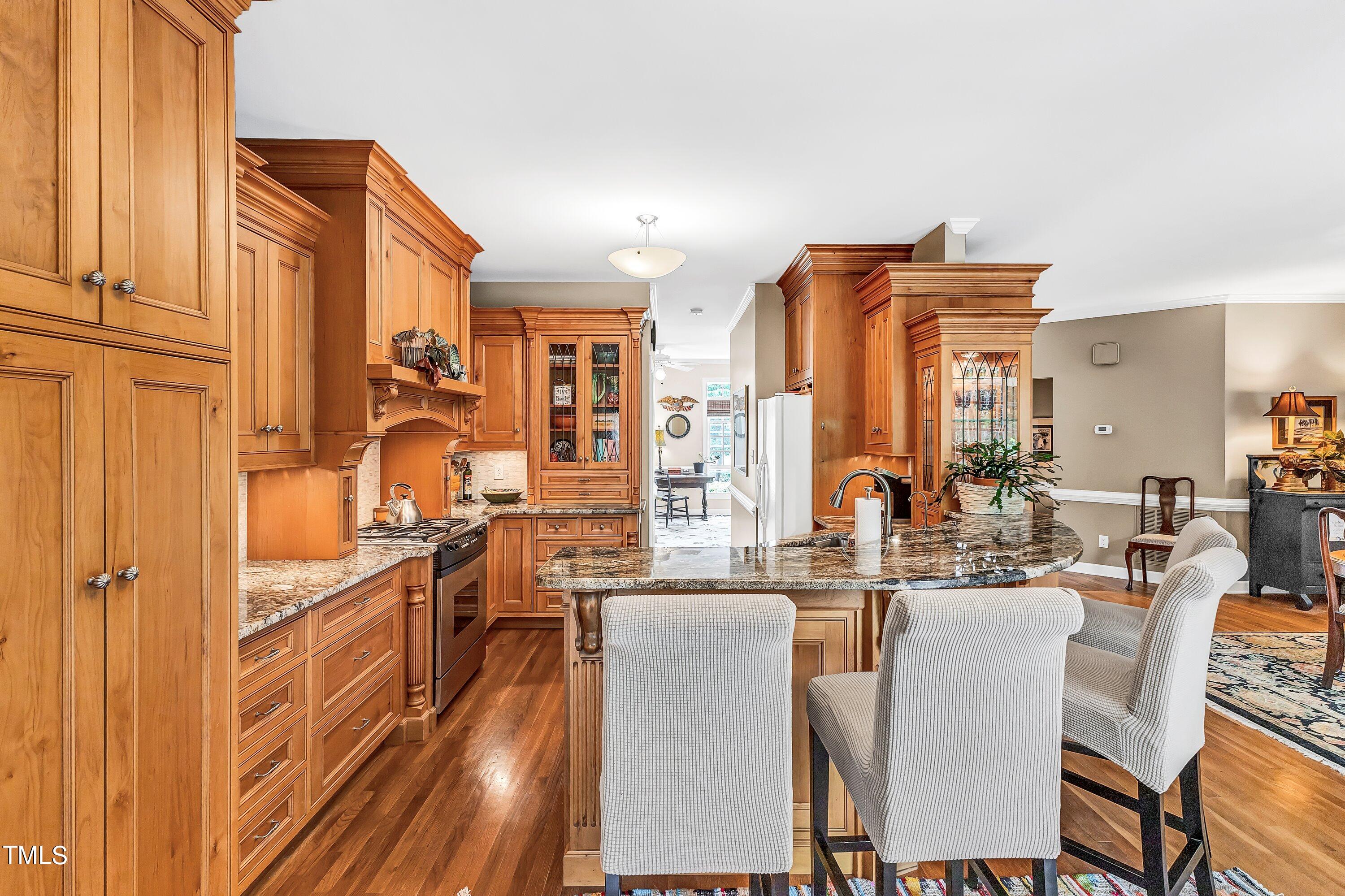 6105 Montcastle Court Raleigh, NC 27612 - Photo 16 of 44 a dining room with furniture and a chandelier