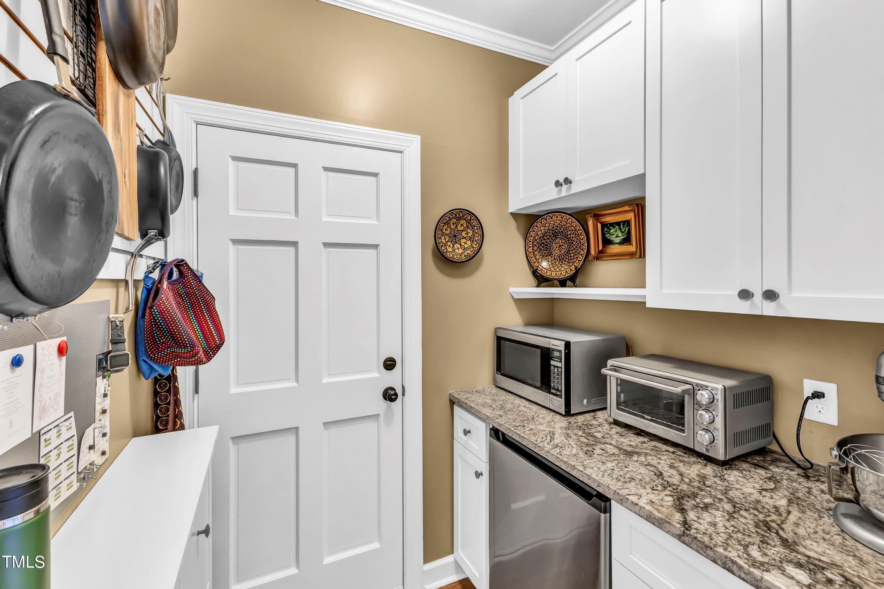 6105 Montcastle Court Raleigh, NC 27612 - Photo 19 of 44 a kitchen with stainless steel appliances granite countertop a refrigerator and a stove top oven