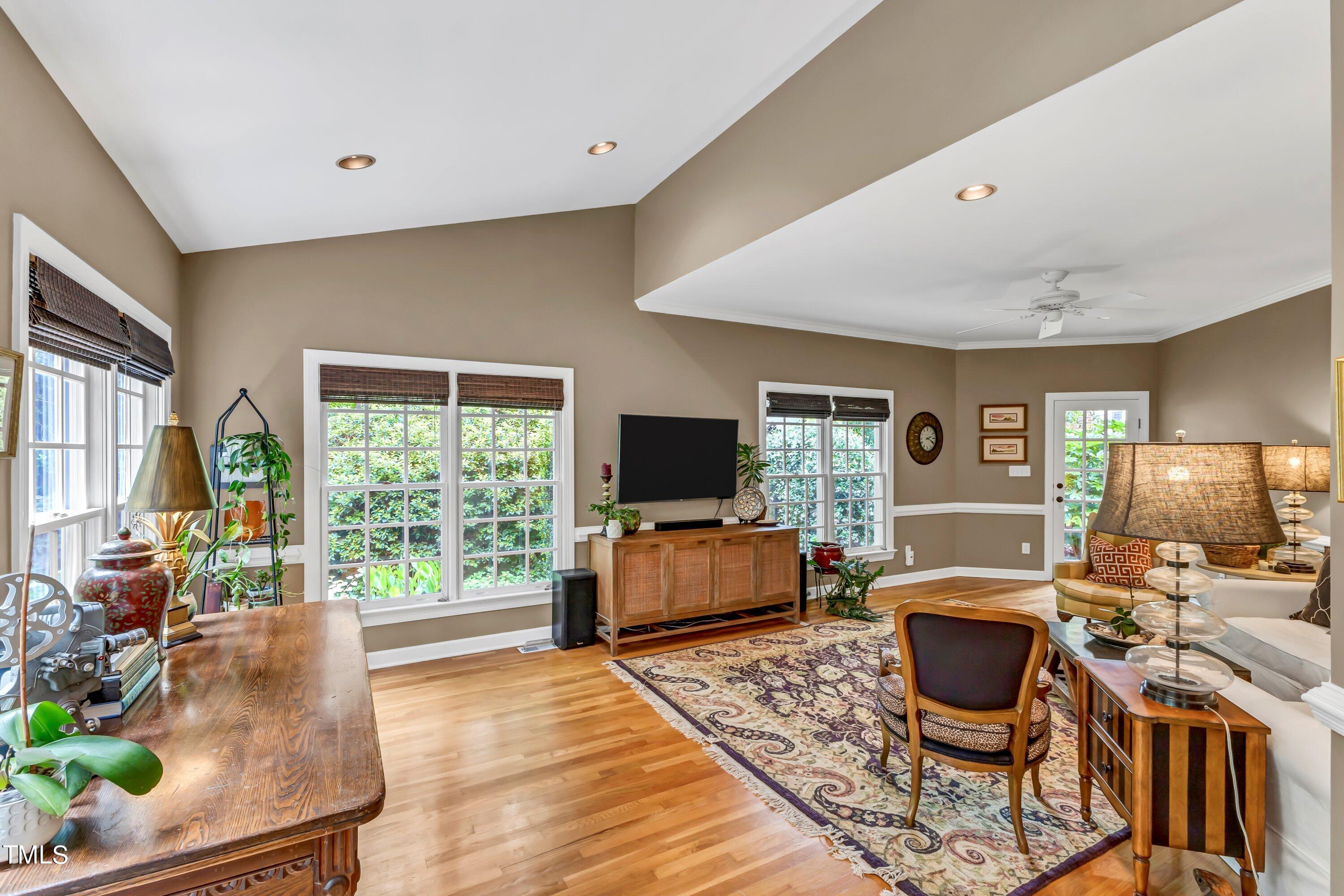 6105 Montcastle Court Raleigh, NC 27612 - Photo 20 of 44 a living room with furniture and a flat screen tv