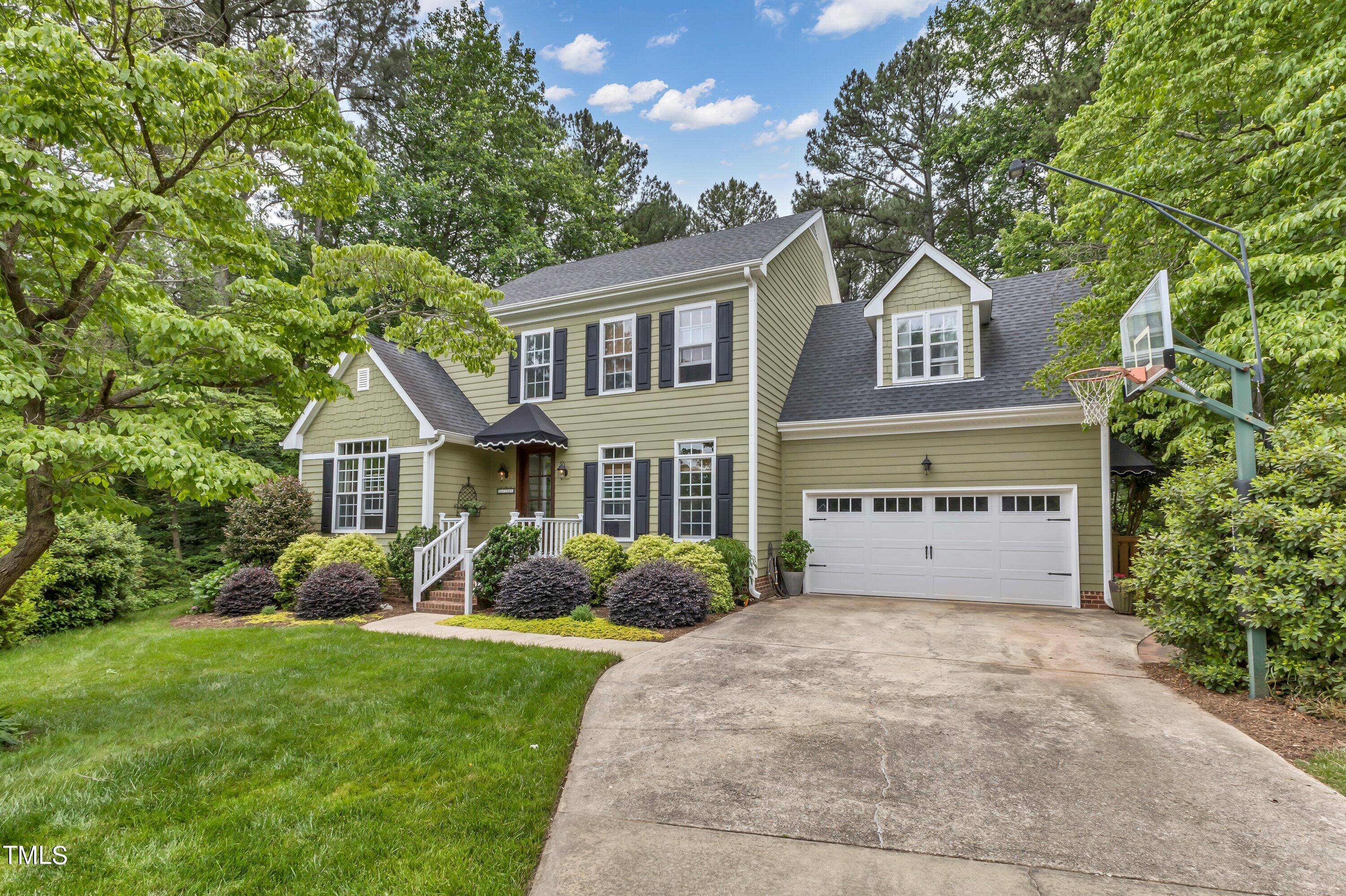6105 Montcastle Court Raleigh, NC 27612 - Photo 2 of 44 a front view of a house with garden